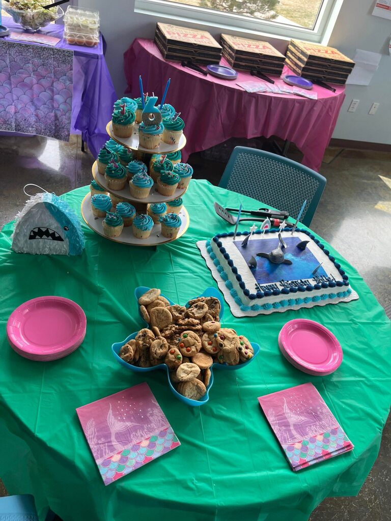 mermaid themed party table with cupcaes and starfish shaped bowl filled with treats